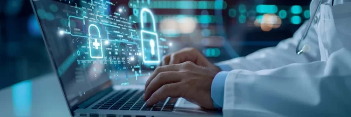 Doctor using a laptop with digital security graphics overlay, representing data protection and cybersecurity in healthcare.