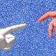 human hand reaching toward robot hand for A.I.