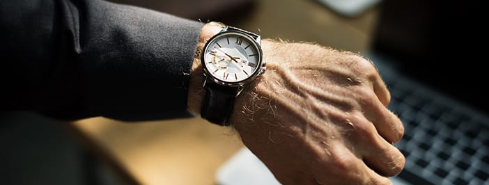 hand with wristwatch and suit