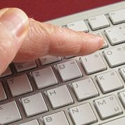 hand covering keyboard for blog about 3 tips for stronger passwords you can actually remember