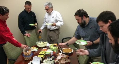 Infinity employees at office potluck